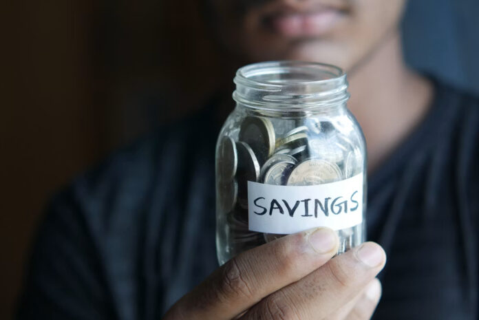 A South African person planning their finances by balancing saving and investing to build long-term financial security and prepare for emergencies.